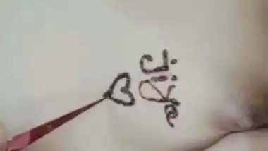 Nude girl puts henna on her naked body during a video call sex